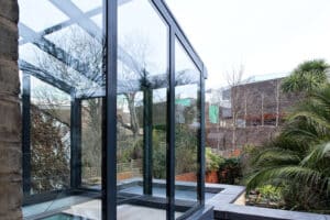 Lean-to glass roof above fixed frame glazing