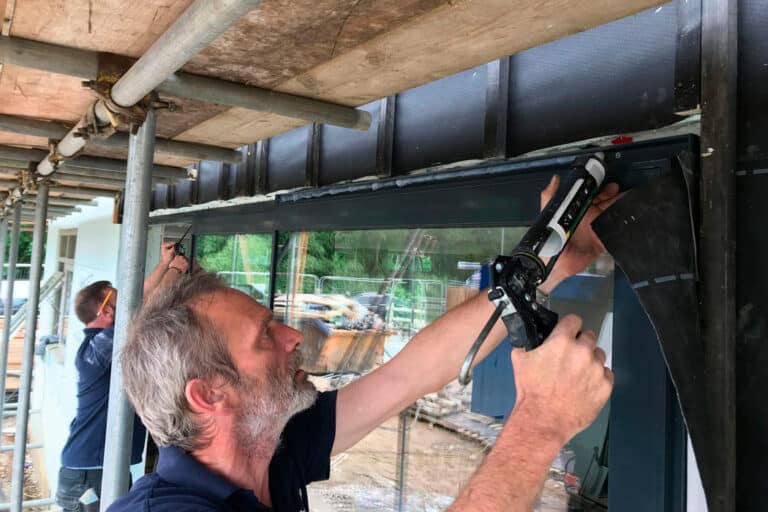 Installing the sliding doors at Build it Selfbuild Education House at Graven Hill in Bicester