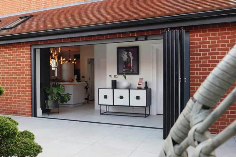 Red brick extension with vistaline slide & turn doors and courtyard garden