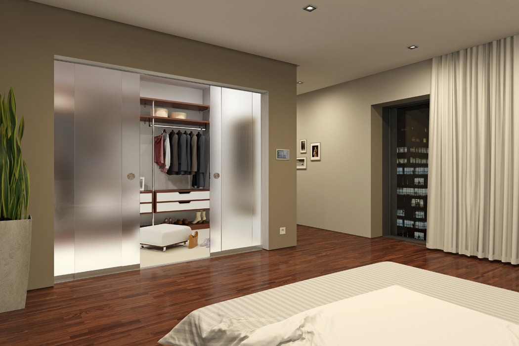 Modern bedroom with SF20 frameless glass sliding doors opening to illuminated walk-in wardrobe, showcasing slim-profile aluminium frames and minimalist design.