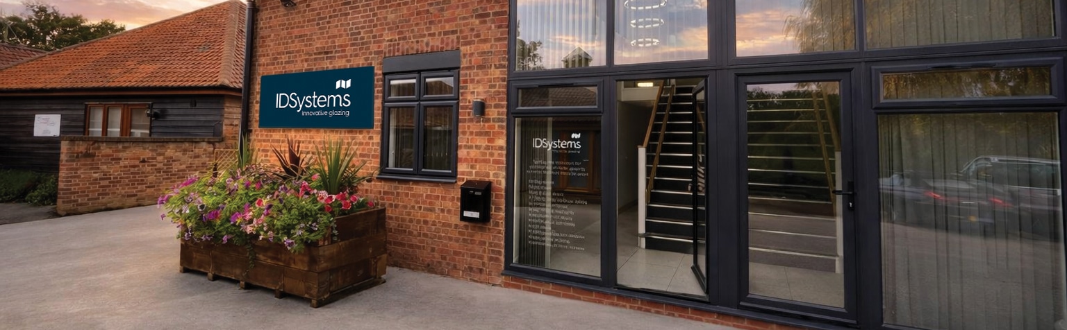 IDSystems showroom exterior featuring modern glazing solutions and premium aluminium doors with slim-profile frames.