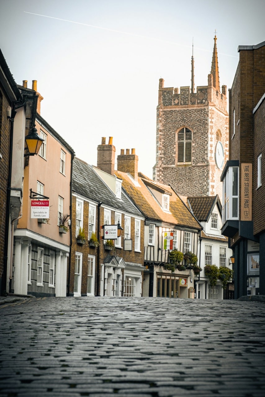 Historic Norwich street with church spire, leading to IDSystems showroom location in charming medieval town centre.