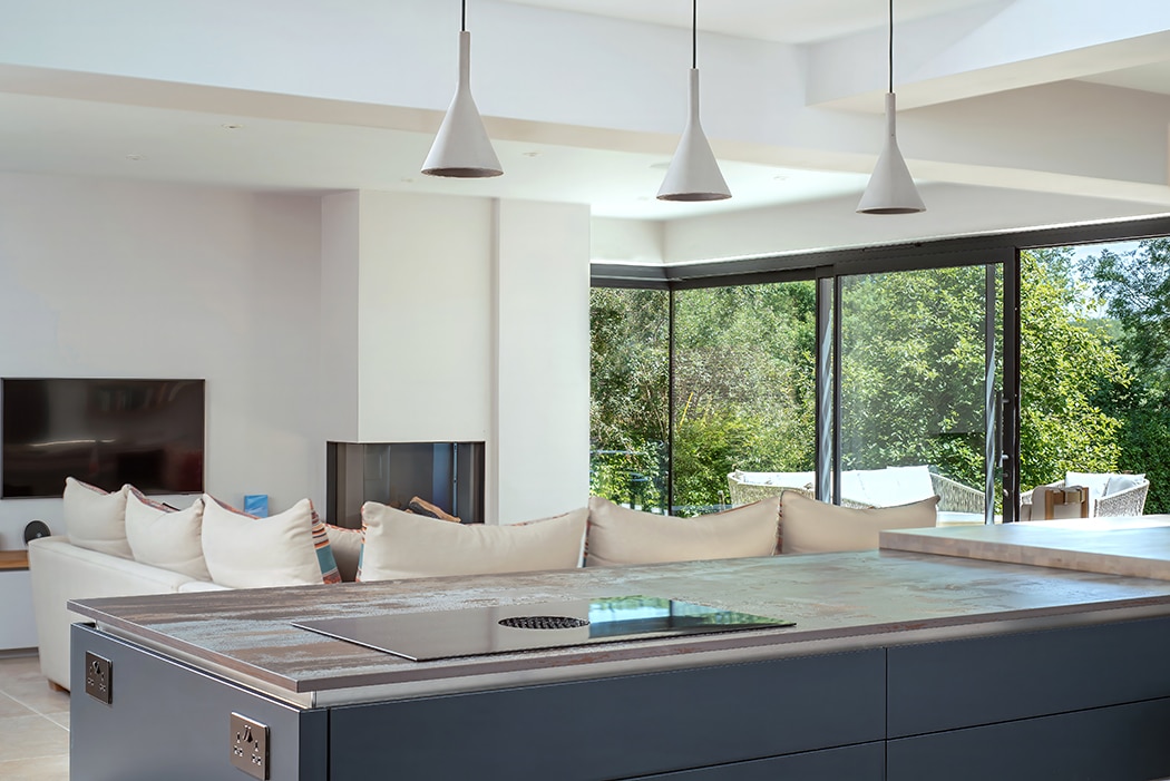 Contemporary glazing transforms a 1950s Wiltshire home, featuring expansive sliding doors opening to outdoor space.